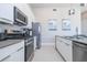 Modern kitchen with stainless steel appliances and an island at 7740 Sandy Ridge Dr # 9-236, Kissimmee, FL 34747