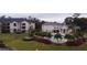 Aerial view of apartment buildings, pool, and surrounding grounds at 940 Village Trl # 9-303, Port Orange, FL 32127