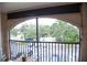 Balcony with table, chairs, and view of trees at 940 Village Trl # 9-303, Port Orange, FL 32127