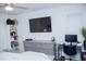 Bedroom with a wall-mounted TV, dresser, workspace, and window at 940 Village Trl # 9-303, Port Orange, FL 32127