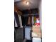 Spacious walk-in closet filled with organized clothing and storage boxes at 940 Village Trl # 9-303, Port Orange, FL 32127