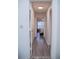 Hallway leading to a bedroom, featuring wood-look flooring at 940 Village Trl # 9-303, Port Orange, FL 32127