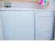 Compact laundry area with white washer and dryer units at 940 Village Trl # 9-303, Port Orange, FL 32127