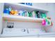 Laundry room with washer, dryer, and storage shelves stocked with cleaning supplies at 940 Village Trl # 9-303, Port Orange, FL 32127