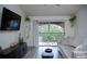 Living room with sliding glass doors leading to a balcony, a couch, and a TV at 940 Village Trl # 9-303, Port Orange, FL 32127