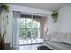 Living room with balcony access, comfortable seating, and plants at 940 Village Trl # 9-303, Port Orange, FL 32127