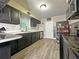 Modern kitchen featuring dark wood cabinets and updated flooring at 1048 Wakefield Cir, Deltona, FL 32725
