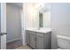 Modern bathroom with gray vanity, white countertop, and spacious mirror at 1541 Goblet Cove St, Kissimmee, FL 34746