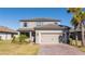 Two-story home with gray siding, tile roof, and a two-car garage at 1541 Goblet Cove St, Kissimmee, FL 34746