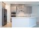 Modern kitchen with gray cabinets, stainless steel appliances, and white countertops at 1541 Goblet Cove St, Kissimmee, FL 34746