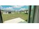 View of backyard with grassy area and neighboring homes at 1963 Turtle Dove Ln, Kissimmee, FL 34746