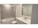 Bathroom boasts a bathtub, sink, and gray tile at 1963 Turtle Dove Ln, Kissimmee, FL 34746