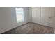 Simple bedroom with window, closet, and neutral carpeting at 1963 Turtle Dove Ln, Kissimmee, FL 34746