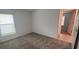 Well-lit bedroom with window, carpet, and access to another room at 1963 Turtle Dove Ln, Kissimmee, FL 34746