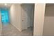 Bright hallway with tile floors and access to multiple rooms at 1963 Turtle Dove Ln, Kissimmee, FL 34746