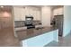 Modern kitchen with white cabinets, stainless steel appliances and island at 1963 Turtle Dove Ln, Kissimmee, FL 34746