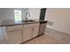 Kitchen island with double sink and stainless steel dishwasher at 1963 Turtle Dove Ln, Kissimmee, FL 34746