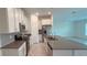 Modern kitchen with white cabinets, stainless steel appliances and island at 1963 Turtle Dove Ln, Kissimmee, FL 34746