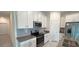 Modern kitchen features stainless steel appliances and gray tile backsplash at 1963 Turtle Dove Ln, Kissimmee, FL 34746