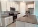 Modern kitchen with white cabinets, stainless steel appliances and island at 1963 Turtle Dove Ln, Kissimmee, FL 34746