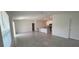 Open living room with kitchen island and grey tile floors at 1963 Turtle Dove Ln, Kissimmee, FL 34746