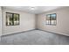 Well-lit bedroom featuring grey carpet and dual pane windows at 3743 Red Oak Ct, Lake Wales, FL 33898