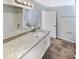 Bathroom features a granite countertop, white cabinets, and a double vanity at 4026 Tenita Dr, Winter Park, FL 32792