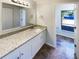 Bathroom boasts a granite countertop, white cabinets, and a double vanity at 4026 Tenita Dr, Winter Park, FL 32792