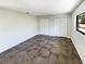 Simple bedroom with dark brown tiled floors and built-in closets at 4026 Tenita Dr, Winter Park, FL 32792
