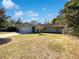 House exterior with a light-grey facade, attached garage, and spacious front yard at 4026 Tenita Dr, Winter Park, FL 32792