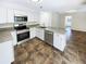 Modern kitchen with white cabinets, granite countertops, and stainless steel appliances at 4026 Tenita Dr, Winter Park, FL 32792