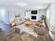 Spacious living room with a stone fireplace, tiled floors, and comfortable seating at 4026 Tenita Dr, Winter Park, FL 32792