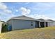House exterior, featuring a screened patio and well-maintained lawn at 4815 Rigging St, Haines City, FL 33844