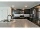 Modern kitchen with dark cabinetry and stainless steel appliances at 4815 Rigging St, Haines City, FL 33844