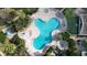 An aerial view of a sparkling community pool and hot tub at 6165 Carrier Dr # 2103, Orlando, FL 32819