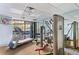 Well-equipped gym with Cybex machines and pool view at 6165 Carrier Dr # 2103, Orlando, FL 32819