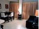 Living room features a black couch and a dining table at 6165 Carrier Dr # 2103, Orlando, FL 32819