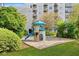 Community playground with playset and sandpit at 6165 Carrier Dr # 2103, Orlando, FL 32819
