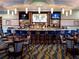 Community clubhouse bar with seating and multiple screens at 8979 Azalea Sands Ln, Davenport, FL 33896