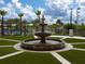 Landscaped courtyard with a large water fountain at 8979 Azalea Sands Ln, Davenport, FL 33896
