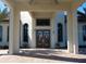 Elegant entryway with double doors and a covered porch at 8979 Azalea Sands Ln, Davenport, FL 33896