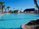 Resort-style pool with surrounding lounge chairs and a tiki bar at 8979 Azalea Sands Ln, Davenport, FL 33896