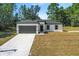 Newly constructed home with gray garage door and driveway at 16921 Sw 25Th Ct, Ocala, FL 34473