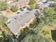 Aerial view of townhouses showcasing the back exterior, landscaping, and a paved pathway at 2020 Retreat View Cir, Sanford, FL 32771