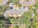 Aerial view of a row of townhouses with gray roofs and yellow siding at 2020 Retreat View Cir, Sanford, FL 32771