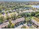 Aerial view of townhouses situated in a tree-lined neighborhood near a lake at 2020 Retreat View Cir, Sanford, FL 32771