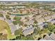 Aerial view of a large community of townhouses, featuring a pond and surrounding landscape at 2020 Retreat View Cir, Sanford, FL 32771