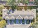 Aerial view of townhouses with gray roofs and yellow siding, featuring a community layout at 2020 Retreat View Cir, Sanford, FL 32771