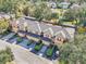 Aerial view of a row of townhouses with garages and neatly manicured landscaping at 2020 Retreat View Cir, Sanford, FL 32771