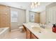 Bathroom with updated vanity and tiled bathtub at 2020 Retreat View Cir, Sanford, FL 32771